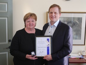 Linda Stevenson of St. Thomas poses with the Caring Canadian Award she recently won, and Elgin-Middlesex-London MPP Jeff Yurek. Stevenson was recognized at Queen's Park last week for her extensive engagement in improving education, athletics and healthcare in her community. (Ben Forrest, Times-Journal)