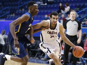 Carleton's Philip Scrubb against Windsor's Rotimi Osuntola Jr in OUA basketball semifinal action on Feb. 28, 2014. (Craig Robertson/Toronto Sun/QMI Agency)