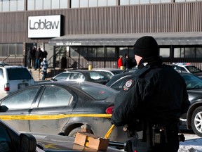 Edmonton Police Service officers investigate after two people were killed and four others injured in a multi-stabbing at a Loblaws Companies Limited warehouse at 16104 121A Avenue in Edmonton, Alta., on Friday, Feb. 28, 2014. Ian Kucerak/Edmonton Sun/QMI Agency
