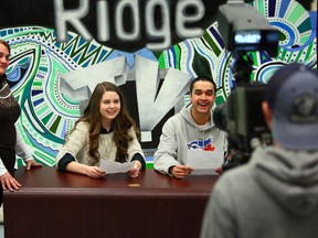 Teacher Tiffany Olmstead coaches Grade 12 students Emma Coates, 17, and Mikail Rehman, 17, duuring their daily newscast at Iroquois Ridge High School. (DAVE ABEL/Toronto Sun)