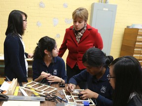 Madonna Catholic Secondary School principal Erica Wilson drops in on students in a robotics class. (VERONICA HENRI/Toronto Sun)