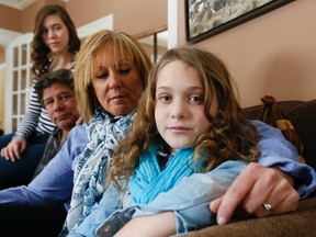 Madi Vanstone, 12,  with her mom Beth, dad Glenn and sister Jesse at their home outside of Beeton, Ont. on March 1, 2014. (Stan Behal/Toronto Sun)