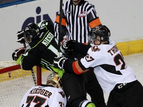 Edmonton Oil Kings' Riley Kieser is pushed into the net by Calgary Hitmen's Ben Thomas at Rexall Place in Edmonton, Alberta on Friday, March 1, 2014.  Perry Mah/ Edmonton Sun/ QMI Agency