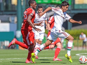 Fluminense’s Igor Juliao and TFC’s Doneil Henry chase down the ball during Saturday’s game. (USA TODAY SPORTS)