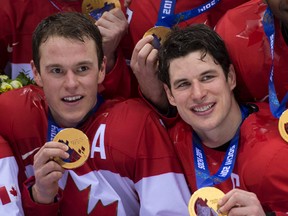 Team Canada's Jonathan Toews (left) and Sidney Crosby celebrate with their Olympic gold medals. (BEN PELOSSE/QMI AGENCY)