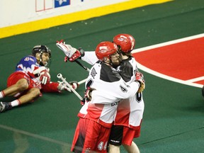 Dane Dobbie and Matthew Dinsdale of the Roughnecks celebrate a goal near Damon Edwards of the Rock during NLL action in Calgary last night. Toronto lost 19-13. (Lyle Aspinall/QMI Agency)