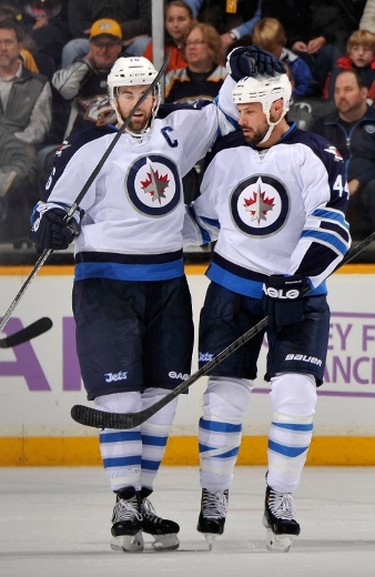 NASHVILLE, TN - MARCH 01: Andrew Ladd #16 and Zach Bogosian #44 of the Winnipeg Jets celebrate a goal against the Nashville Predators at Bridgestone Arena on March 1, 2014 in Nashville, Tennessee.   Frederick Breedon/Getty Images/AFP
== FOR NEWSPAPERS, INTERNET, TELCOS & TELEVISION USE ONLY ==