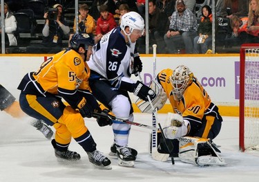 NASHVILLE, TN - MARCH 01: Blake Wheeler #26 of the Winnipeg Jets charges the net and goalie Carter Hutton #30 of the Nashville Predators at Bridgestone Arena on March 1, 2014 in Nashville, Tennessee.   Frederick Breedon/Getty Images/AFP
== FOR NEWSPAPERS, INTERNET, TELCOS & TELEVISION USE ONLY ==