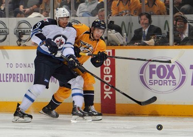 NASHVILLE, TN - MARCH 01: Simon Moser #21 of the Nashville Predators skates against Evander Kane #9 of the Winnipeg Jets at Bridgestone Arena on March 1, 2014 in Nashville, Tennessee.   Frederick Breedon/Getty Images/AFP
== FOR NEWSPAPERS, INTERNET, TELCOS & TELEVISION USE ONLY ==