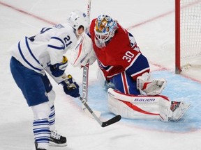 Maple Leafs' James van Riemsdyk goes in on Montreal Canadiens goalie Peter Budaj (QMI Agency)