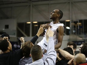 Ottawa Gee-Gees supporters carry Johnny Berhanemeskel after his dramatic game-winning shot against the Carleton Ravens in the OUA final on March 1. (Craig Robertson, Toronto Sun)