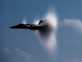 An F/A-18C Hornet fighter jet assigned to Strike Fighter Squadron (VFA) 113 breaks the sound barrier during an air power demonstration over the USS Carl Vinson aircraft carrier and Carrier Air Wing 17 in the Pacific Ocean in this U.S. Navy handout photo dated June 3, 2011. (REUTERS/U.S. Navy/Mass Communication Specialist 3rd Class Travis K. Mendoza/Handout)