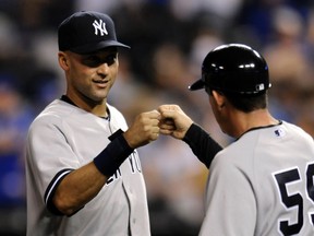 Yankees star Derek Jeter with coach Robbie Thomson (Reuters)