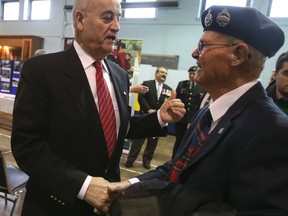 Veteran Affairs Minister Julian Fantino shakes hands with 94-year-old veteran Russel Smith, 94, of Oshawa, who fought in Normandy in the Second World War. (JACK BOLAND, Toronto Sun)