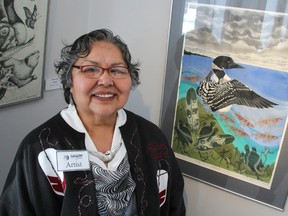 Teresa Altiman is one of several First Nations artists featured at Gallery in the Grove's Animikii Noodinag - Thunder Winds exhibition that opened Sunday. She's pictured here with her 2009 painting Water Spirit Celebrate. The exhibition runs until April 12. TYLER KULA/ THE OBSERVER/ QMI AGENCY