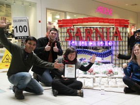 Team Suncor walked away with the Judges' Favourite award at this year's CANstruction build in Sarnia. Team members on hand to accept the award Sunday were Abhi Durge, left, Raymond Rodrigue, Jennifer Johnson, Michelle McDonald, and John Kuruvilla. The event raises food and funds for the Inn of the Good Shepherd's food bank. TYLER KULA/ THE OBSERVER/ QMI AGENCY