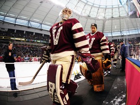 Vancouver Canucks goalies Eddie Lack (left) and Roberto Luongo head to the locker room for the second intermission during the Heritage Classic game against the Ottawa Senators at BC Place in Vancouver, March 2, 2014. (ANNE-MARIE SORVIN/USA Today)