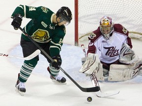 Knights Ryan Rupert can?t control a rebound in front of Peterborough Petes goalie Andrew D?Agostini at Budweiser Gardens on Sunday. The Knights lost 3-1. (MIKE HENSEN, The London Free Press)