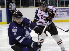 Sarnia Legionnaires' forward Josh Kestner (in white) attempts to lift the stick of London Nationals' defenceman Anthony Kotsovos during game 3 of their GOJHL Western Conference quarter final playoff match up on Sunday evening. Kestner had three goals and an assist in a 5-4 Sarnia win, which brings the series to 2-1 in favour of London. SHAUN BISSON/THE OBSERVER/QMI AGENCY