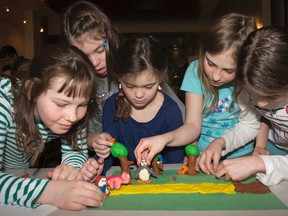 Tess O'Callaghan, Madison Ball, Jessie Ball, Lydia Morrow and Isobel Moore work on their groups animated film at the Kids Animated Workshop, hosted by the Kingston Canadian Film Festival,  a free event held in the Davies Lounge at the Grand Theatre on Saturday. (Julia McKay/The Whig-Standard)