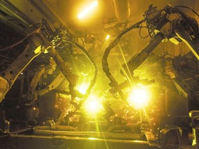 Massive robots weld frames for trucks at Formet in St. Thomas, a Magna company that employs 1,450. (File photo)