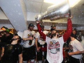 Michal Handzus of the Chicago Blackhawks celebrates with the Stanley Cup in the locker room after his team defeated the Boston Bruins in Game Six of their NHL Stanley Cup finals in Boston, Mass. June 24, 2013. (DAVE SANDFORD/Reuters)