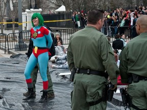 A protester is arrested as students demonstrate against the proposed Keystone XL pipeline in front of the White House in Washington, D.C., on March 2, 2014. (AFP PHOTO/Nicholas Kamm)