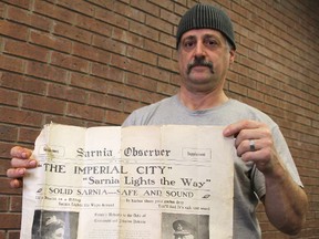 Sarnia man Steve Senchuk holds a rare copy of a May 7, 1914 Observer newspaper. The supplement details the Royal visit to Sarnia when it was officially named a city. TYLER KULA/ THE OBSERVER/ QMI AGENCY
