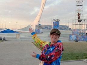 Local curler Mitzi Koebernick proudly stands in front of the Olympic torch while in Russia for the Sochi Winter Games. This is the second time Koebernick has attended an Olympic event as a curling statistician have gone to Vancouver in 2010.