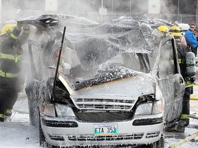 Firefighters work on a multi vehicle fire in the parking lot of the Superstore at Sargent and St. James in Winnipeg, Man. Monday March 03, 2014. (Brian Donogh/Winnipeg Sun/QMI Agency)