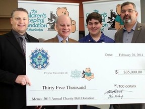Winnipeg Police Association president Mike Sutherland, left, and Vice-president George van Mackelbergh, right, present a cheque for $35,000 to Children's Hospital CEO Lawrence Prout and cancer survivor Ryan Veldkamp, the 2014 child of the year. (HANDOUT)