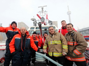Adrian Lwekici, centre left, senior marine captain on the Toronto Fire Department fire boat the William Lyon Mackenzie, and his crew on Thursday, February 27, 2014. (Michael Peake/Toronto Sun)