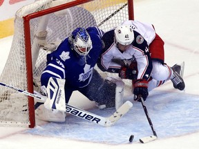 Maple Leafs goalie James Reimer is hit by Columbus' Cam Atkinson at the ACC on Monday night. (Michael Peake/Toronto Sun)