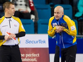 Team Manitoba skip Jeff Stoughton (left) talks to Team Alberta skip Kevin Koe before their draw during the 2014 Brier curling championship in Kamloops, B.C., March 3, 2014. (BEN NELMS/Reuters)