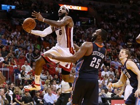 Miami Heat small forward LeBron James drives to the basket past Charlotte Bobcats centre Al Jefferson at American Airlines Arena in Miami, March 3, 2014. (ROBERT MAYER/USA Today)