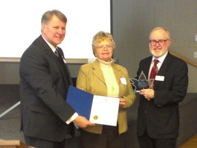 St. Clair Region Conservation Authority chair Steve Arnold, left, and vice-chair Terry Burrell, right, present an award to Sydenham Field Naturalists president Denise Shephard at the Authority's annual general meeting held Feb. 20 in Dresden.