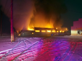 The Rocky Mountain Mechanical building on the east end of Main St. completely engulfed as fire crews work to control the blaze early Tuesday morning. Greg Cowan photo/QMI Agency.