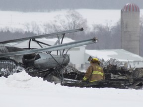 A small crew of fire fighters sift through what is left of a barn on St. Augustine Line northeast of Goderich in Ashfield-Colborne-Wawanosh township.