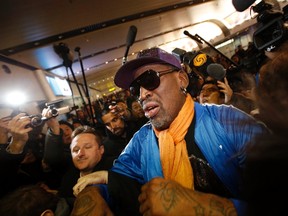 Retired U.S. basketball star Dennis Rodman is surrounded by journalists upon his arrival from North Korea's Pyongyang at Beijing Capital International Airport January 13, 2014. (REUTERS)