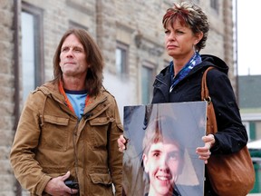 Willy and Kelly Stevenson, holding a life size photo of their late son Aaron, speak to the media outside of Brockville court following a recent sentencing hearing for Rusty Pearce and Joseph Greer. (RECORDER AND TIMES FILE PHOTO).