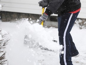 Curtis Walls, 38, shovels his neighbour's Devine Street driveway in Sarnia, Ont. Friday Feb. 8, 2013. Walls said he usually shovels for his neighbour since the man has difficulty shoveling for himself. TYLER KULA/ THE OBSERVER/ QMI AGENCY