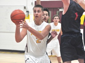 Taylor Alarie of the PCI Trojans JV team dishes the ball during the Trojans' 72-52 division semifinal loss to Shaftesbury Mar. 4 (Kevin Hirschfield/THE GRAPHIC/QMI AGENCY)