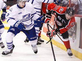 Ottawa 67's Connor Brown avoids the check of Mississauga Steelheads Greg DiTomaso during OHL hockey action at the Canadian Tire Centre on Tuesday March 04,2014. 
Errol McGihon/Ottawa Sun/QMI Agency
