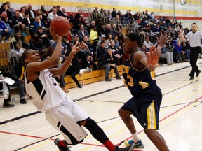 Eastern Commerce’s Jason McDonald gets a shot off against Oakwood’s Russell Baker during the quarterfinal at OFSAA in Mississauga. Oakwood won and will play Notre Dame in the semis. In the other semifinal match, Father Henry Carr will take on d'Youville. (Michale Peake/Toronto Sun)