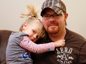 Two-year-old Faith Murray, pictured with dad, Randy, at home on Tuesday March 4, 2014, was suspended from her daycare after she brought a cheese sandwich to school. Darren Brown/Ottawa Sun/QMI Agency