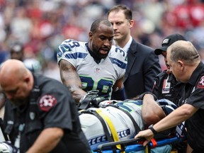 Seattle Seahawks cornerback Brandon Browner (39) talks to defensive end Michael Bennett (72) as Bennett is carried off the field during the second quarter against the Houston Texans at Reliant Stadium on Sep 29, 2013 in Houston, TX, USA. (Troy Taormina/USA TODAY Sports)