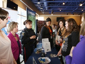 Alexandra Holmes, left, Sheila Kelly-Petrin and Const. Hally Willmott, of the Greater Sudbury Police booth, talk to a group of students at the annual Women of the Future Conference at Cambrian College on Tuesday. More than 100 Grade 9 and 10 female students from 10 Sudbury area high schools attended the event to learn about a number of career options and to hear stories from women in the community. JOHN LAPPA/THE SUDBURY STAR/QMI AGENCY