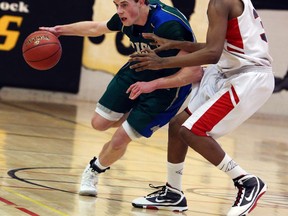 Cormac Brown of the St. Patrick's Fighting Irish (in green) attempts to drive around Eastern Commerce's Kasey Morris during their opening round match up at the OFSAA "AAAA" basketball championships on Monday March 3, 2014. (Dave Thomas, QMI Agency)