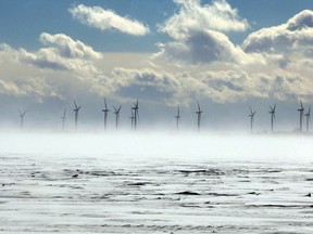 The wind turbines on Wolfe Island are partially obscured by blowing snow during a cold and windy winter day in Kingston recently. 
IAN MACALPINE/KINGSTON WHIG-STANDARD/QMI AGENCY