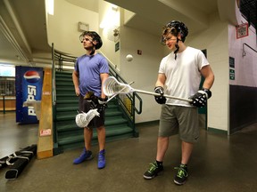 Riley Loewen, left, and Robert Church, shown here helping out at a Vimy Ridge School lacrosse practice, have filled in a couple of crucial roles with the Edmonton Rush this season. (Perry Mah, Edmonton Sun)